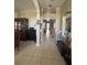 Hallway with tile flooring and decor, with a view of the dining area and front door at 4436 Horseshoe Pick Ln, Valrico, FL 33594