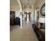 Hallway featuring neutral walls, tile flooring, and decorative accents, leading towards the front entrance at 4436 Horseshoe Pick Ln, Valrico, FL 33594