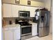 Kitchen features stainless steel appliances, white cabinets and an open layout at 4436 Horseshoe Pick Ln, Valrico, FL 33594
