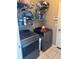 Laundry room with side-by-side gray washer and dryer and white storage shelves at 4436 Horseshoe Pick Ln, Valrico, FL 33594