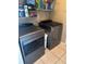Laundry room with side-by-side gray washer and dryer and white storage shelves at 4436 Horseshoe Pick Ln, Valrico, FL 33594