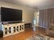 Living area featuring wood floors, media center, and comfortable seating at 4436 Horseshoe Pick Ln, Valrico, FL 33594