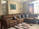 Spacious living room featuring a comfortable, oversized sectional sofa and neutral walls at 4436 Horseshoe Pick Ln, Valrico, FL 33594
