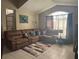 A bright living room shows a neutral color scheme, large arched window, and sectional sofa at 4436 Horseshoe Pick Ln, Valrico, FL 33594
