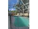 Enclosed backyard pool with view of palm trees and residential homes at 4436 Horseshoe Pick Ln, Valrico, FL 33594