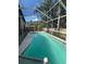 Beautiful backyard pool enclosed with screening, featuring clear water and lush greenery at 4436 Horseshoe Pick Ln, Valrico, FL 33594