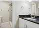 Bathroom featuring modern vanity, granite countertop, and tiled shower at 4607 N Country Hills Ct, Plant City, FL 33566