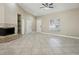 Spacious living room featuring a stone fireplace, tile flooring, and natural light at 4607 N Country Hills Ct, Plant City, FL 33566