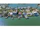 Aerial view showcasing waterfront homes, private docks, and sparkling blue water at 487 Harbor S Dr, Indian Rocks Beach, FL 33785