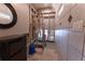 Tiled bathroom with a modern shower, round mirror, and woven storage unit at 487 Harbor S Dr, Indian Rocks Beach, FL 33785