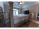 Bedroom featuring a four-poster bed, ceiling fan, and a large window for natural light at 487 Harbor S Dr, Indian Rocks Beach, FL 33785