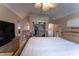 Spacious bedroom featuring a bed, dresser, and a ceiling fan, with a view into an adjoining room at 487 Harbor S Dr, Indian Rocks Beach, FL 33785