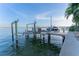 Waterfront dock featuring boat lifts, a spot for jet skis, and serene water views at 487 Harbor S Dr, Indian Rocks Beach, FL 33785