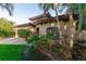Home exterior with lush landscaping, stone accents and a tile roof at 487 Harbor S Dr, Indian Rocks Beach, FL 33785