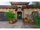 Elegant front exterior with lush landscaping, a grand entrance, and a covered walkway at 487 Harbor S Dr, Indian Rocks Beach, FL 33785