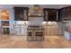 Spacious kitchen area featuring a stainless steel stove and hood with dark cabinets at 487 Harbor S Dr, Indian Rocks Beach, FL 33785
