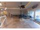 Bright living room with tile flooring, ceiling fan and lots of natural light from sliding glass doors at 487 Harbor S Dr, Indian Rocks Beach, FL 33785