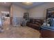 Cozy living room featuring tile flooring, a brown leather couch, and natural light, under renovation at 487 Harbor S Dr, Indian Rocks Beach, FL 33785