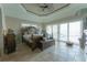 Comfortable main bedroom features large windows, ceiling fan, lots of natural light and ensuite bathroom at 487 Harbor S Dr, Indian Rocks Beach, FL 33785