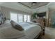 Comfortable main bedroom features large windows, ceiling fan, mounted TV and a dresser at 487 Harbor S Dr, Indian Rocks Beach, FL 33785