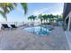 Beautiful waterfront pool featuring an attached spa, sun loungers, and a dock with boat lifts at 487 Harbor S Dr, Indian Rocks Beach, FL 33785