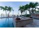 Gorgeous backyard pool with spa, lush landscaping, and serene waterfront views at 487 Harbor S Dr, Indian Rocks Beach, FL 33785