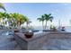 Amazing pool featuring a spa, brick trim, and picturesque waterfront views at 487 Harbor S Dr, Indian Rocks Beach, FL 33785