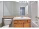 Bathroom featuring oak vanity, large mirror, tub, and view of entryway at 5046 Gato Del Sol Cir, Wesley Chapel, FL 33544