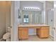 Bathroom featuring a dual sink vanity, large mirror, updated lighting, and a separate shower at 5046 Gato Del Sol Cir, Wesley Chapel, FL 33544