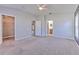Bright bedroom boasts carpeted floors, ceiling fan, two doors and ample space for furniture at 5046 Gato Del Sol Cir, Wesley Chapel, FL 33544