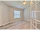Neutral bedroom with a ceiling fan, window with blinds, closet, and wood floors at 5046 Gato Del Sol Cir, Wesley Chapel, FL 33544