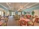 Spacious clubhouse lounge area with ample seating, fireplace, tables, chairs, and decorative accents at 5046 Gato Del Sol Cir, Wesley Chapel, FL 33544