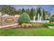 Lexington Oaks community entrance sign surrounded by lush greenery, trees, and a water fountain feature at 5046 Gato Del Sol Cir, Wesley Chapel, FL 33544