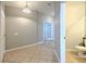 Neutral entryway with tile floor with view of hall and partial bathroom at 5046 Gato Del Sol Cir, Wesley Chapel, FL 33544