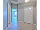 Inviting entryway with neutral colors, tile flooring and a view into a living space at 5046 Gato Del Sol Cir, Wesley Chapel, FL 33544