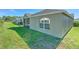 A view of the home's exterior and back lawn, with screened lanai at 5046 Gato Del Sol Cir, Wesley Chapel, FL 33544