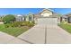 Beautiful home featuring manicured front lawn, driveway, and attached two-car garage at 5046 Gato Del Sol Cir, Wesley Chapel, FL 33544