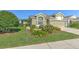 Charming single-Gathering home with lush landscaping and a well-maintained lawn at 5046 Gato Del Sol Cir, Wesley Chapel, FL 33544
