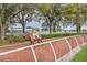 A view of a horse and rider on a horse track with a white fence surrounding it at 5046 Gato Del Sol Cir, Wesley Chapel, FL 33544