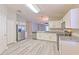 Modern kitchen with stainless steel appliances, gray countertops, and ample cabinet space for storage at 5046 Gato Del Sol Cir, Wesley Chapel, FL 33544