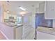 Eat-in kitchen featuring granite countertop, breakfast bar, and stainless appliances at 5046 Gato Del Sol Cir, Wesley Chapel, FL 33544