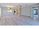 Open living room with modern flooring, neutral paint, ample natural light, and an open floor plan at 5046 Gato Del Sol Cir, Wesley Chapel, FL 33544