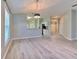 Living room with wood-look floors, view to dining and kitchen with granite countertops at 5046 Gato Del Sol Cir, Wesley Chapel, FL 33544