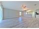 Spacious living room featuring gray wood-look floors and an open floor plan at 5046 Gato Del Sol Cir, Wesley Chapel, FL 33544