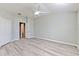 Large primary bedroom with wood floors, light neutral walls, closet, and ensuite access at 5046 Gato Del Sol Cir, Wesley Chapel, FL 33544