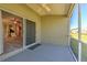 Covered screened patio boasts sliding glass doors to the kitchen with ceiling fan for relaxing outdoors at 5046 Gato Del Sol Cir, Wesley Chapel, FL 33544