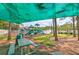Playground area with swings, slides, and a picnic table under the shade of trees at 5046 Gato Del Sol Cir, Wesley Chapel, FL 33544