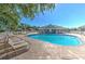 Community pool with plenty of seating and lounge chairs for enjoying the sun and relaxing by the water at 5046 Gato Del Sol Cir, Wesley Chapel, FL 33544
