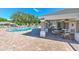 Community pool with chairs and tables under shaded patio provides a relaxing outdoor space at 5046 Gato Del Sol Cir, Wesley Chapel, FL 33544