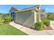 Exterior home side featuring manicured landscaping, and a screened in porch with access to the home at 5046 Gato Del Sol Cir, Wesley Chapel, FL 33544